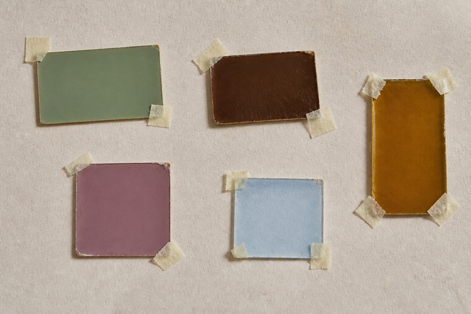 Pigment reference chips in muted green, umber, amber and mauve